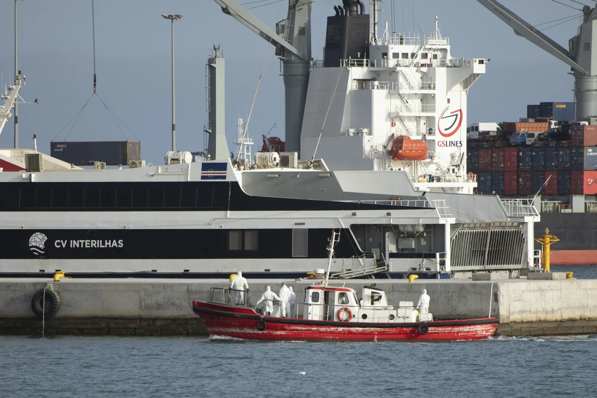 An ambulance boat carrying crew members wearing hazmat suits visits the cruise ship MV Hondius off the coast of Praia, Cape Verde on May 5.
