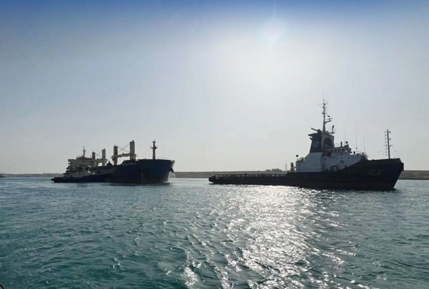 The Xin Hai Tong 23, left, with a marine rescue tug in the Suez Canal on May 25.