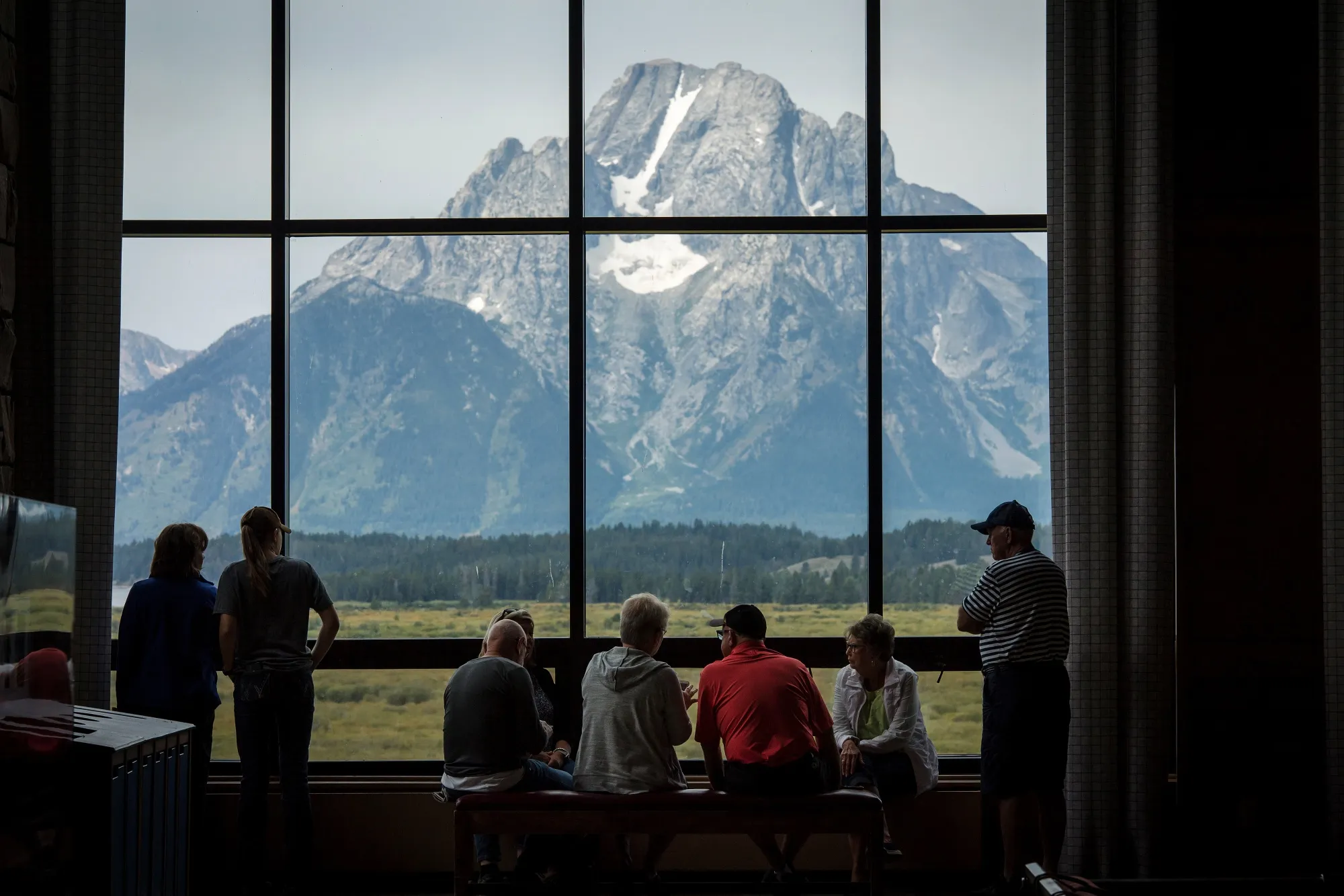 Visitors view the Grand Teton National Park mountain range from the Jackson Lake Lodge in Moran, Wyoming.