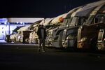 A trucker walks past rigs parked for the night at a TA Travel Center in Greencastle, Pennsylvania.