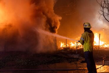 Thousands Flee From Uncontrolled Wildfires Burning Near LA
