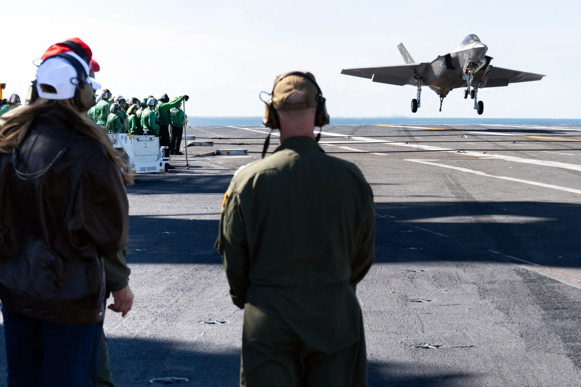 US President Donald Trump, left, and First Lady Melania Trump watch an F-35 land on the carrier deck of the USS George H.W. Bush near Norfolk, Virginia, Oct. 5.