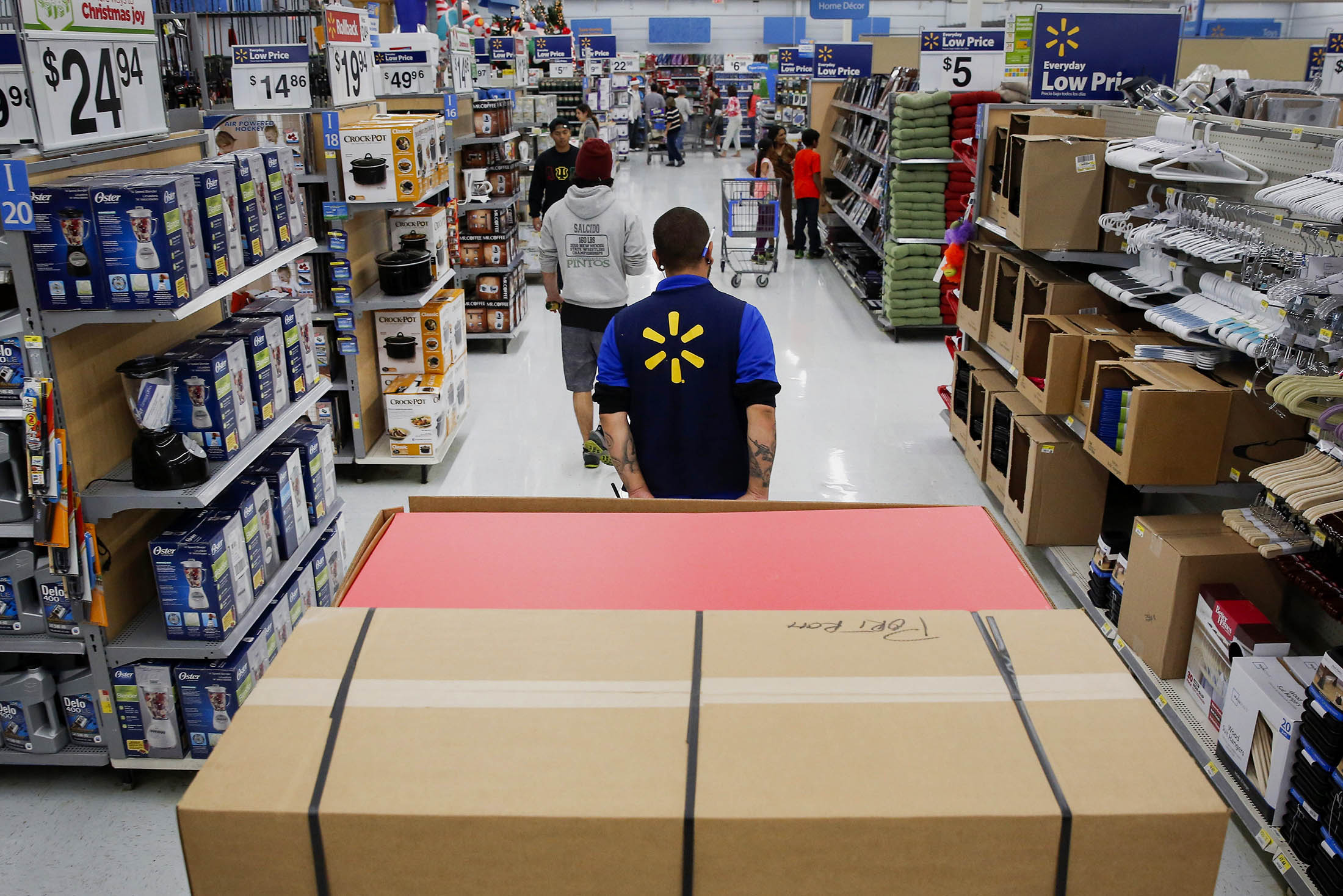 A Wal-Mart employee readies a merchandise at a store in Los Angeles.
