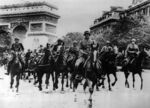 German troops riding through Paris, with the Arc de Triomphe in the background. 