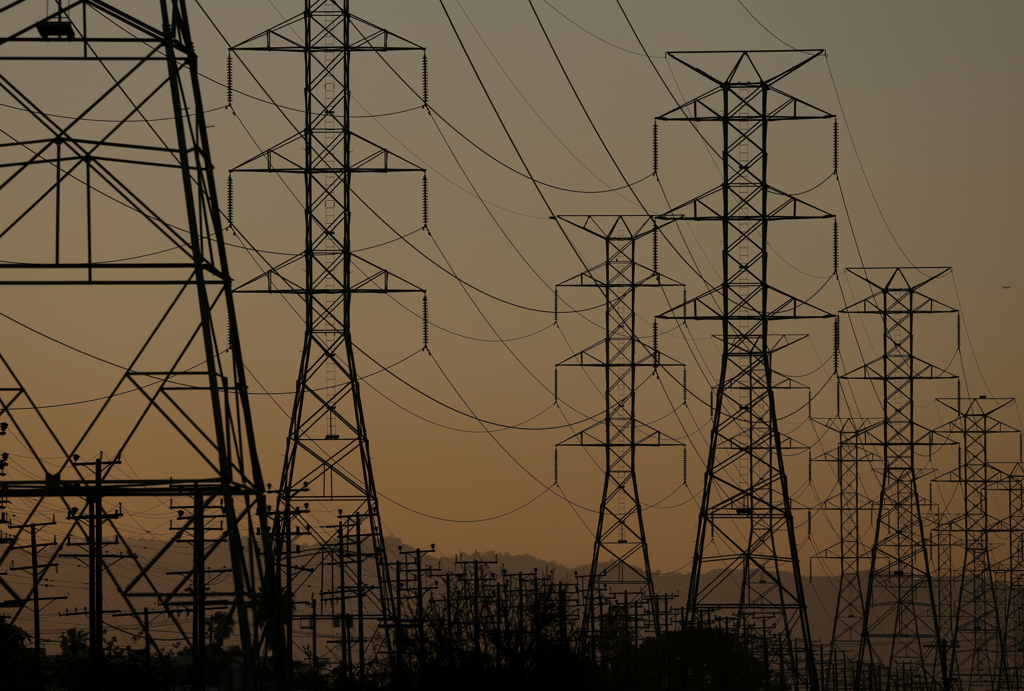 LOS ANGELES, CALIFORNIA - MARCH 25: A general view of electrical transmission towers on March 25, 2026 in Los Angeles, California. Rapid growth in AI-driven data centers, combined with the aging U.S. power grid, is creating large, unpredictable electricity demands that could strain the system and increase the risk of cascading outages if not better managed or upgraded. (Photo by Justin Sullivan/Getty Images)