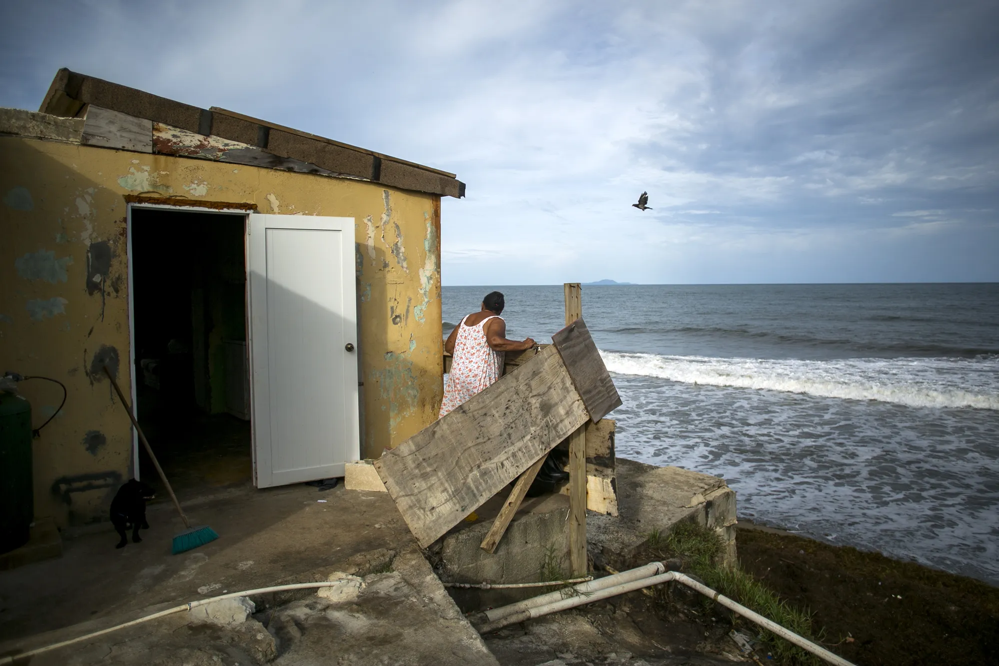 A resident stands outside her home one year after Hurricane Maria knocked out the&nbsp;electricity, in El Negro, Yabucoa, Puerto Rico, on Sept. 17, 2018.&nbsp;
