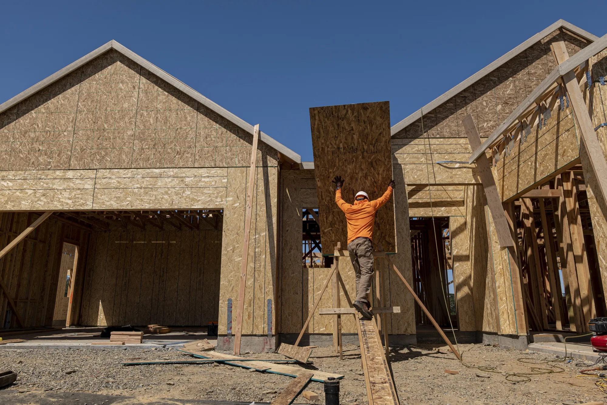 A contractor works on a house under construction in California, US.