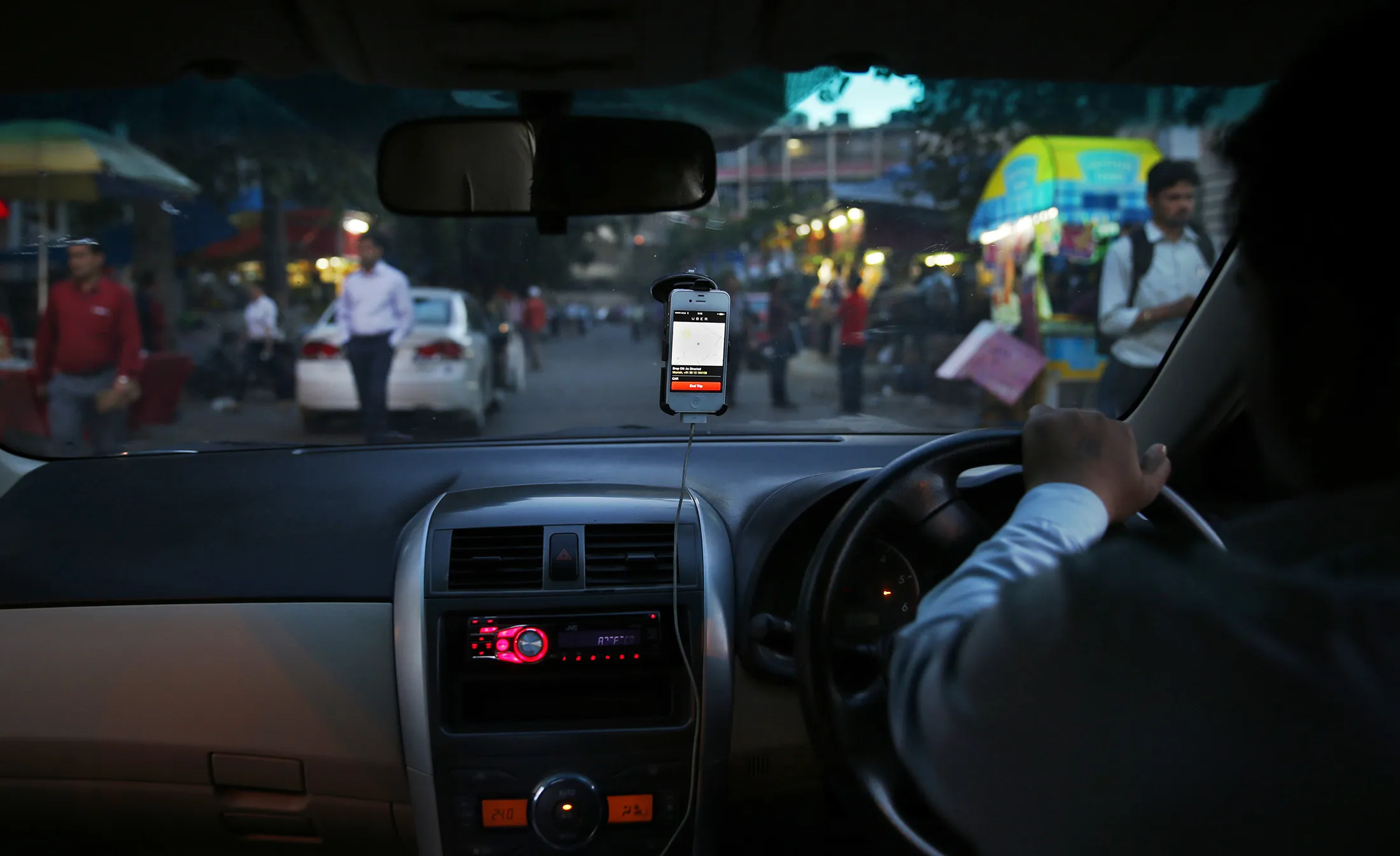 An Uber taxi driver drives his car through a street in New Delhi, India. Riding on its startup success and flush with fresh capital, taxi-hailing smartphone app Uber is making a big push into Asia.
