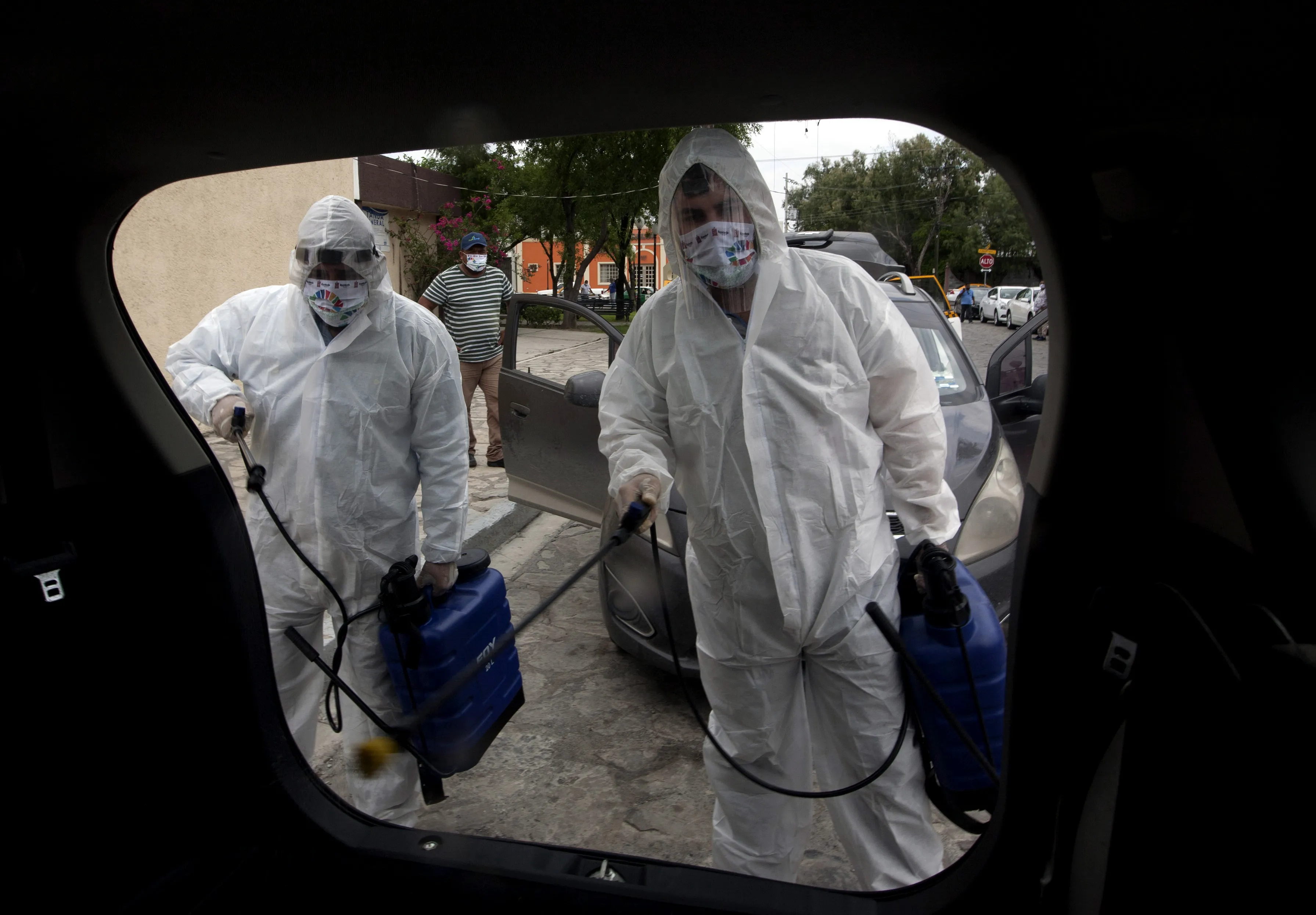 Health workers sanitize private vehicles and taxis in the state of Nuevo Leon, Mexico.