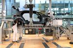 Workers assemble a Volkswagen AG electric automobile at the automaker's factory in Dresden, Germany.
