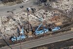 Pacific Gas & Electric Co. (PG&E) employees work to fix downed power lines burned by wildfires in this aerial photograph taken above Santa Rosa, California, on Oct. 12, 2017.&nbsp;