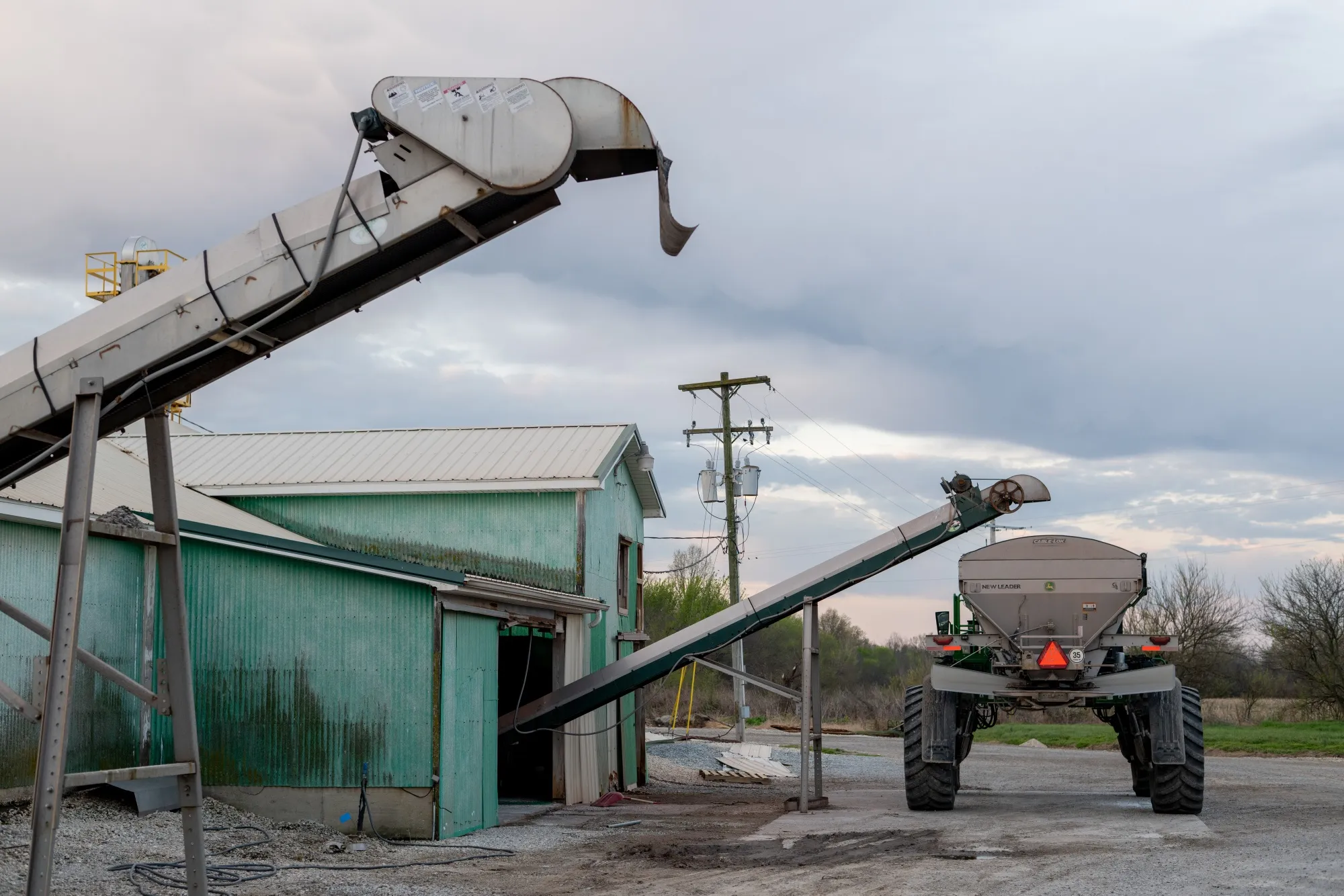 A fertilizer spreader is loaded with granular blend fertilizer near Clinton, Missouri.
