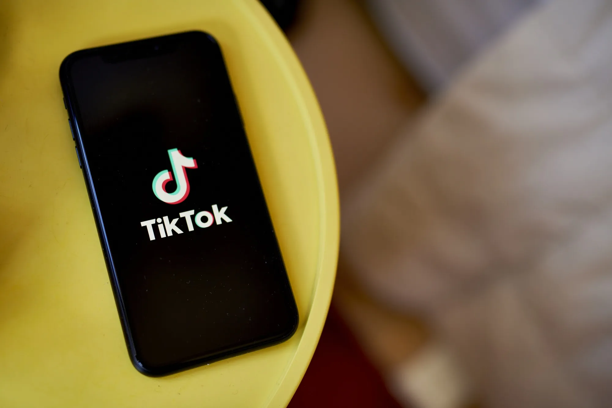 The TikTok logo on a smartphone.