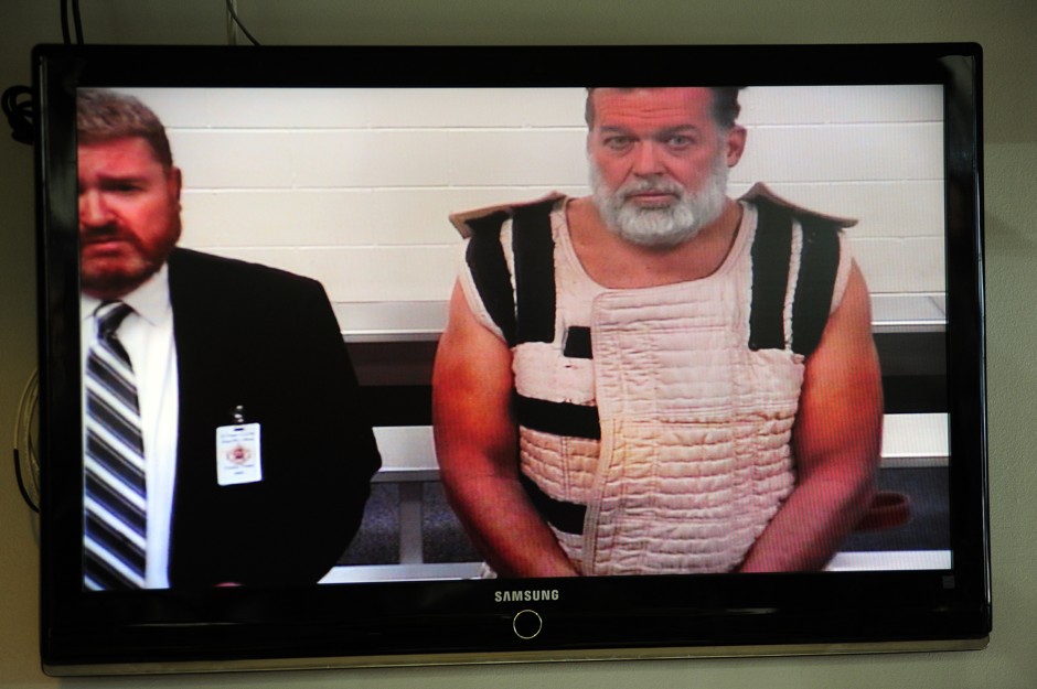 Robert Louis Dear Jr. shown with his defender in a video-recorded appearance before court.