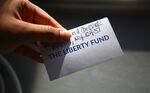 The Liberty Fund's Lisa Whiteside hands out business cards to public defenders and criminal justice activists in the Bronx Criminal Court to spread the word about the fund's existence. 