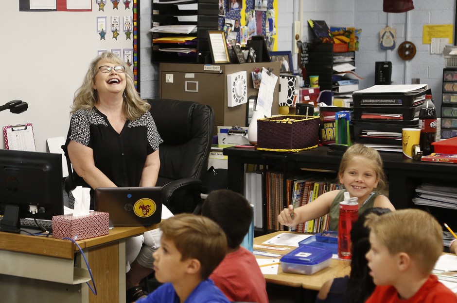 Third-grade teacher Cindy Cordts shares a laugh with her class at Oakwood Elementary School in Peoria, Arizona. The state's teachers won a pay raise in May after a six-day walkout.