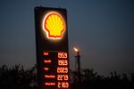 Fuel prices listed on a totem sign at a Shell&nbsp;gas station as a flare stack releases flammable gases at the PCK Schwedt oil refinery.