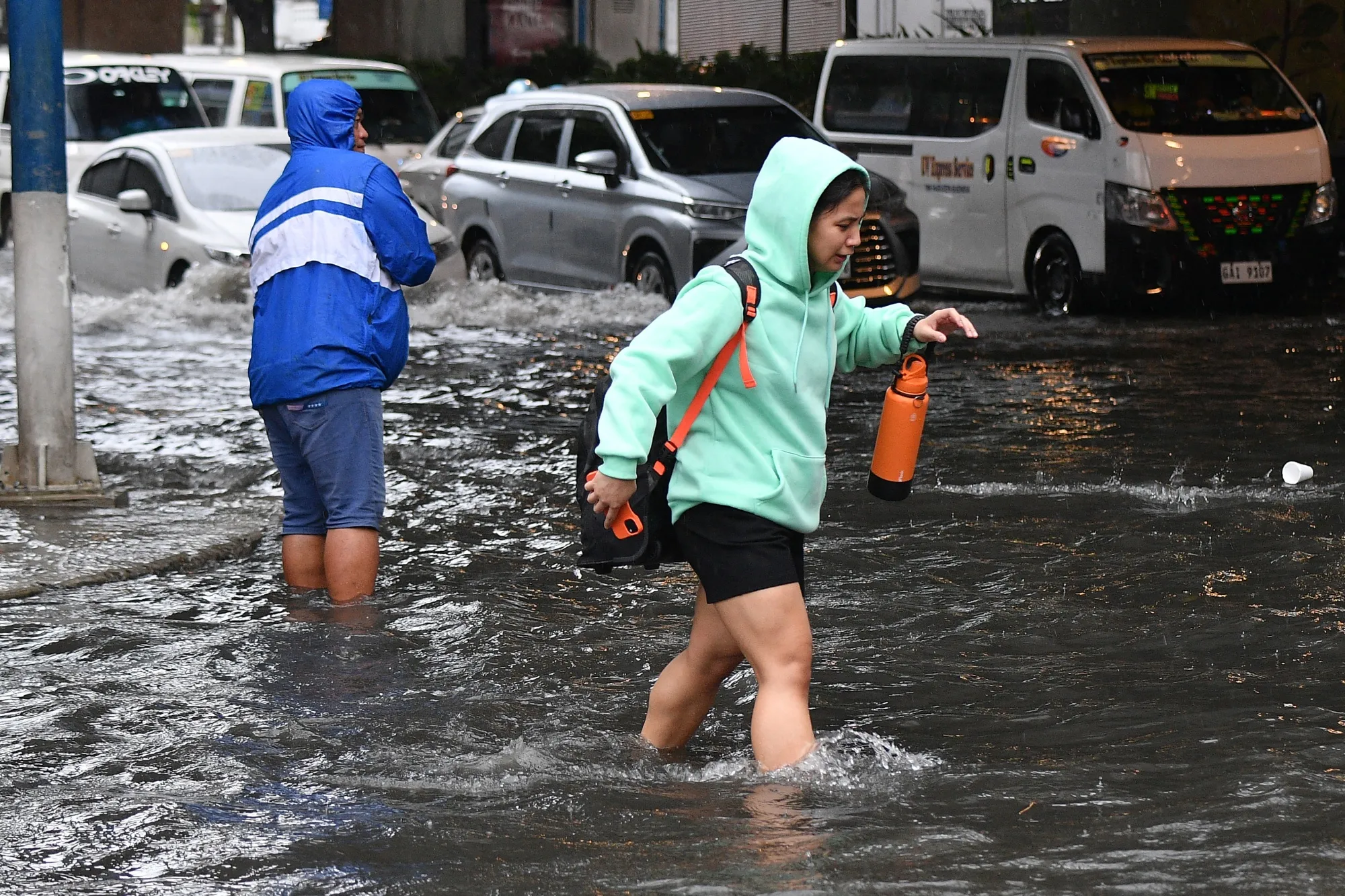 A pedestrian wades through a flooded street amid heavy rains from Typhoon Gaemi on July 23.