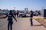 South African police officers in Soweto on July 10 after 14 people where shot dead in a tavern.