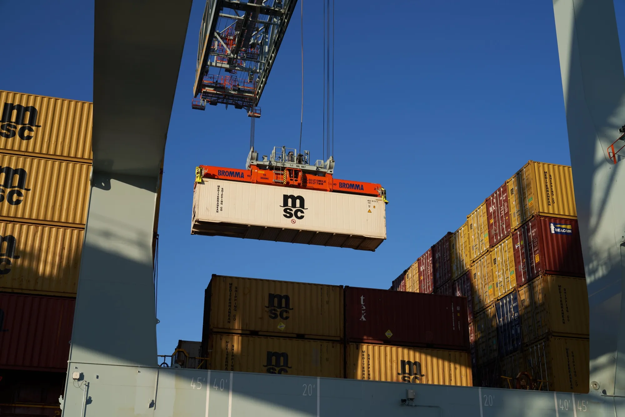 Shipping containers are unloaded off a ship at the Port of Boston's Conley Terminal in Boston, Massachusetts, U.S., on Friday, Jan. 21, 2022. Massport invested $850 million in the Port of Boston Conley Terminal to become big-ship ready and better compete with larger rivals.