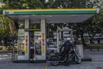 A motorcyclist arrives at a Petroleo Brasileiro SA gas station in Rio de Janeiro, Brazil.