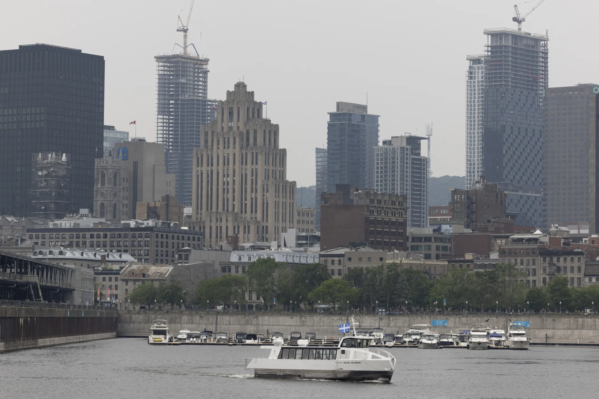 Smoke from wildfires as a water taxi leaves the Old Port of Montreal in Montreal, Quebec, Canada, on Monday, June 6, 2023.&nbsp;Quebec, whose wildfires have darkened the New York skyline&nbsp;is marketing green bonds back at home.