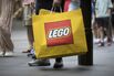 A customer holds a Lego-branded bag outside a Lego Group store in Sydney.