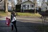 A real estate agent removes an 'Open House' sign in Columbus, Ohio, on Dec. 3, 2017.