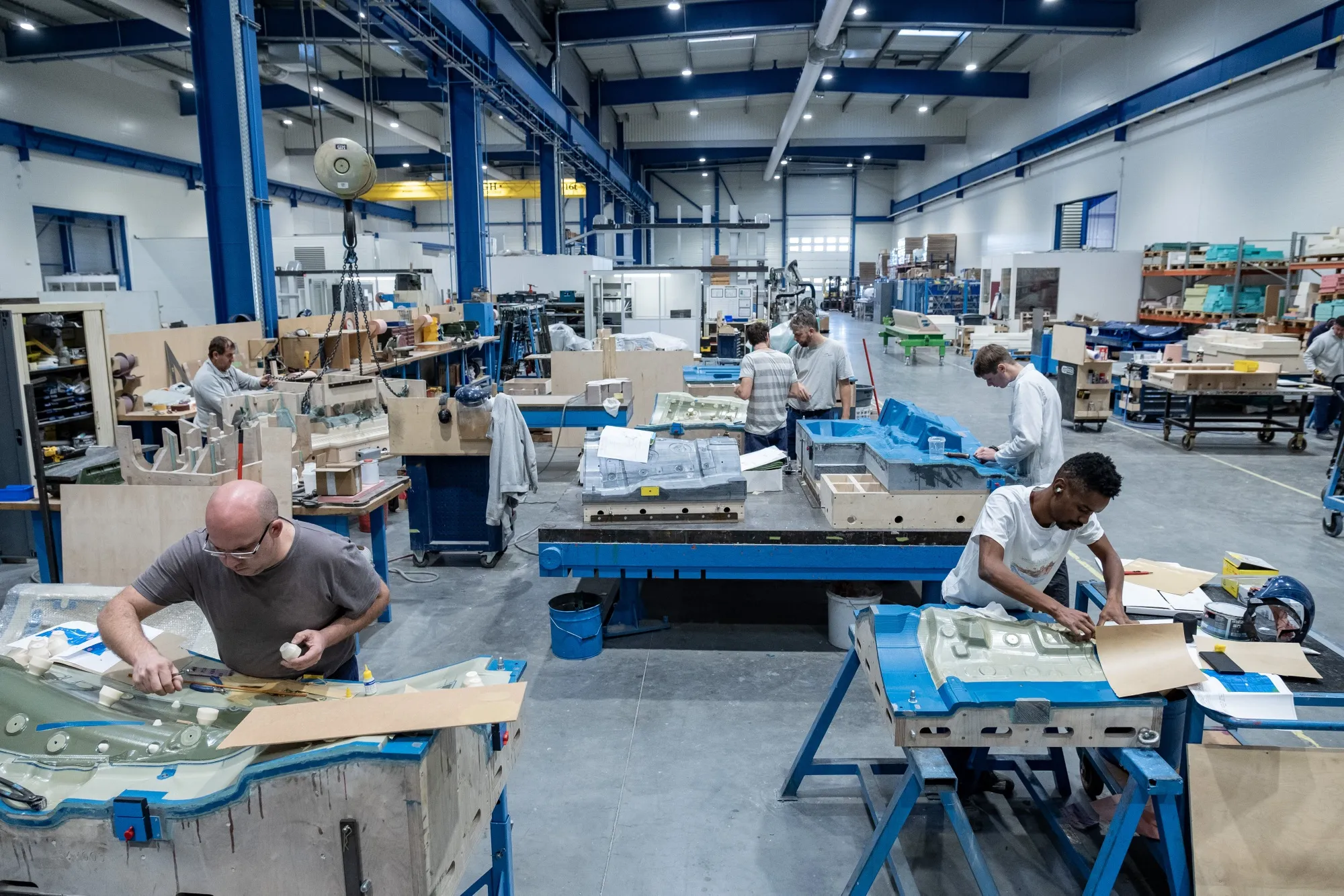 Employees work on the heat insulation finishing line for the Mitsubishi Aircraft Corp. SpaceJet regional jet program inside the Loiretech factory in Bouguenais.