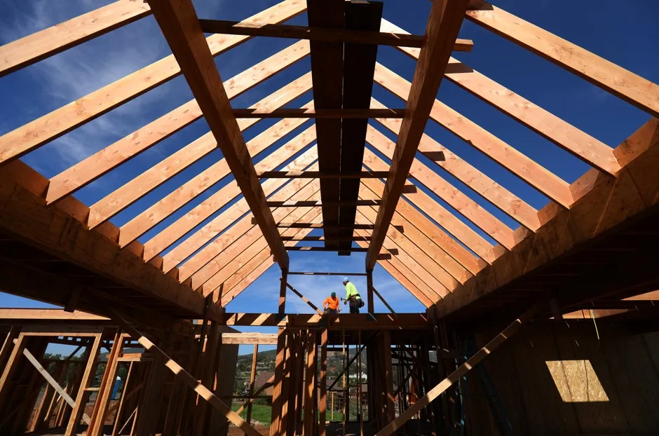 Construction workers build a single-family home in San Diego.