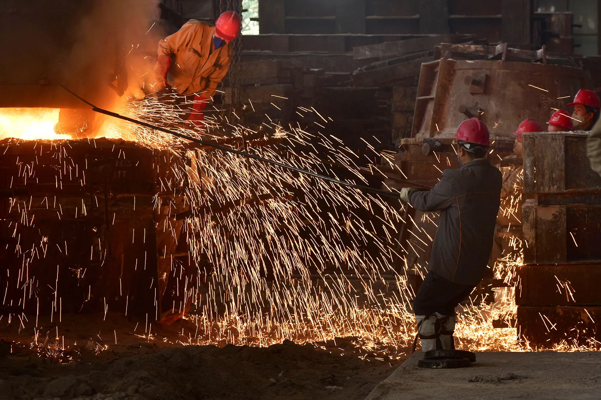 Workers pour molten steel at a foundry in Wuyi, China's eastern Zhejiang province.&nbsp;