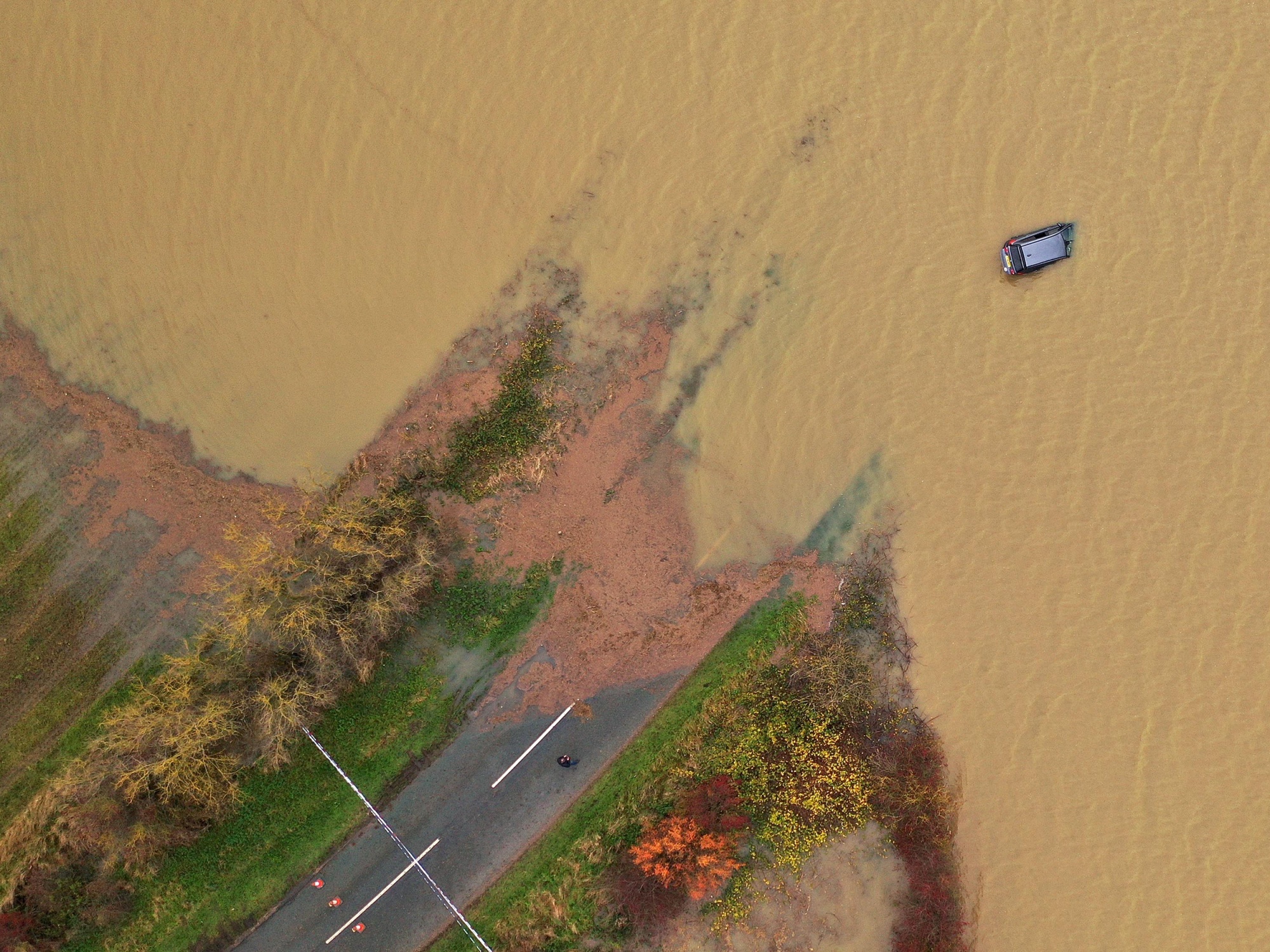 A&nbsp;part submerged&nbsp;car during flooding in the U.K. in October.&nbsp;Companies are being asked how much their mortgage loans could be affected by rising sea levels or flooding.