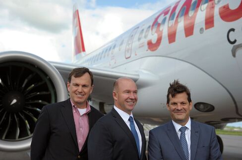 Alain Bellemare, centre, in front of a Bombardier CS100 in Quebec on June 29.