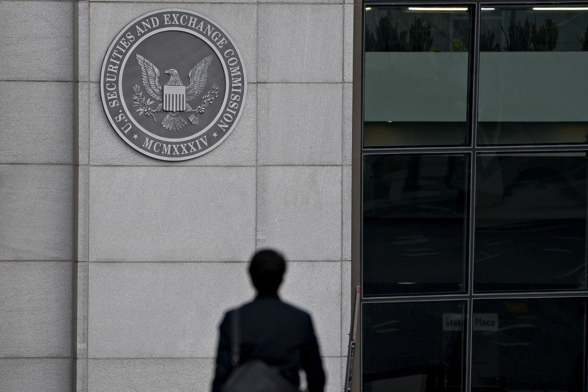 A pedestrian walks near the U.S. Securities and Exchange Commission headquarters in Washington, D.C.