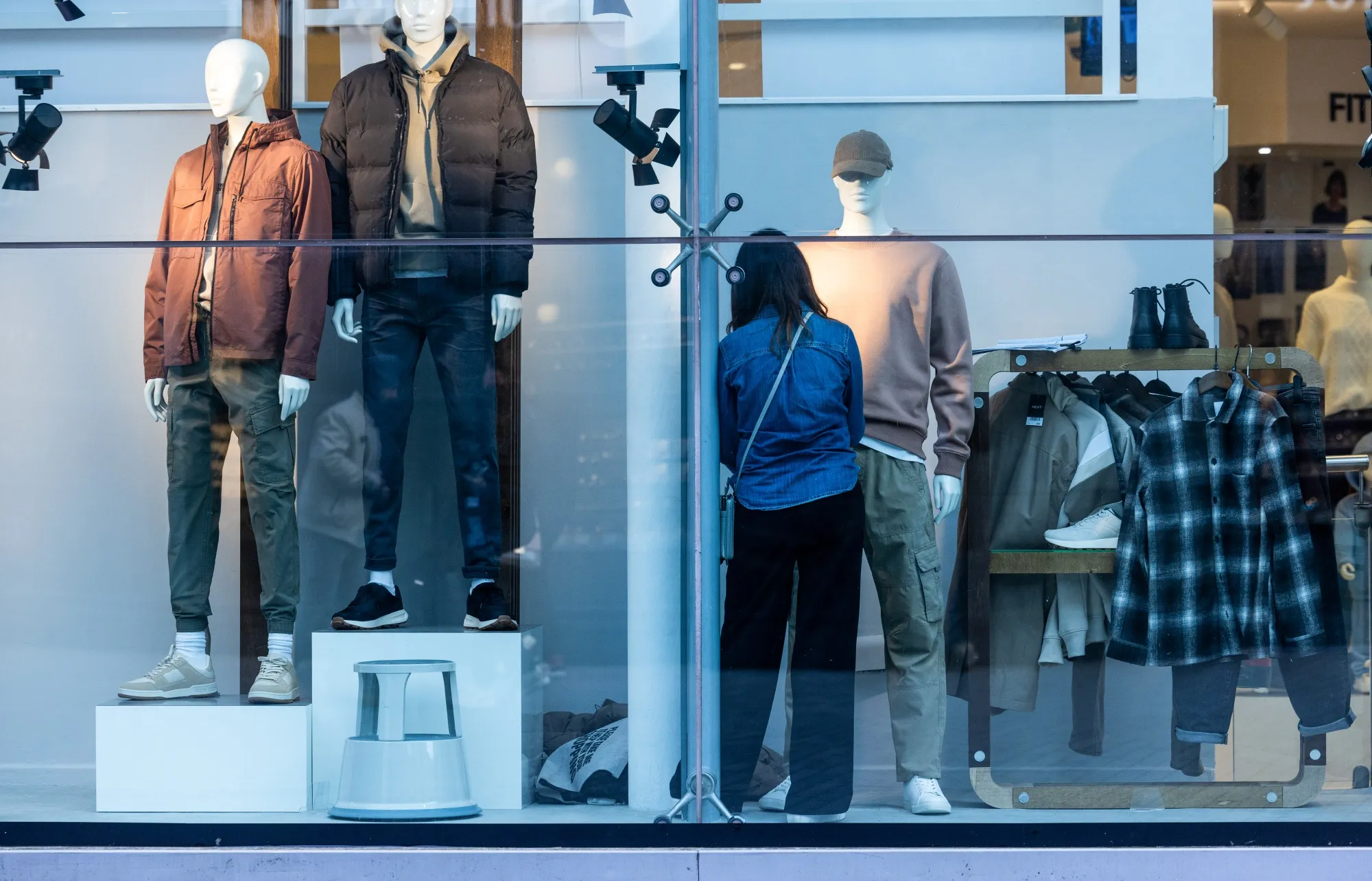 An employee dresses a mannequin at&nbsp;clothing store in Birmingham.