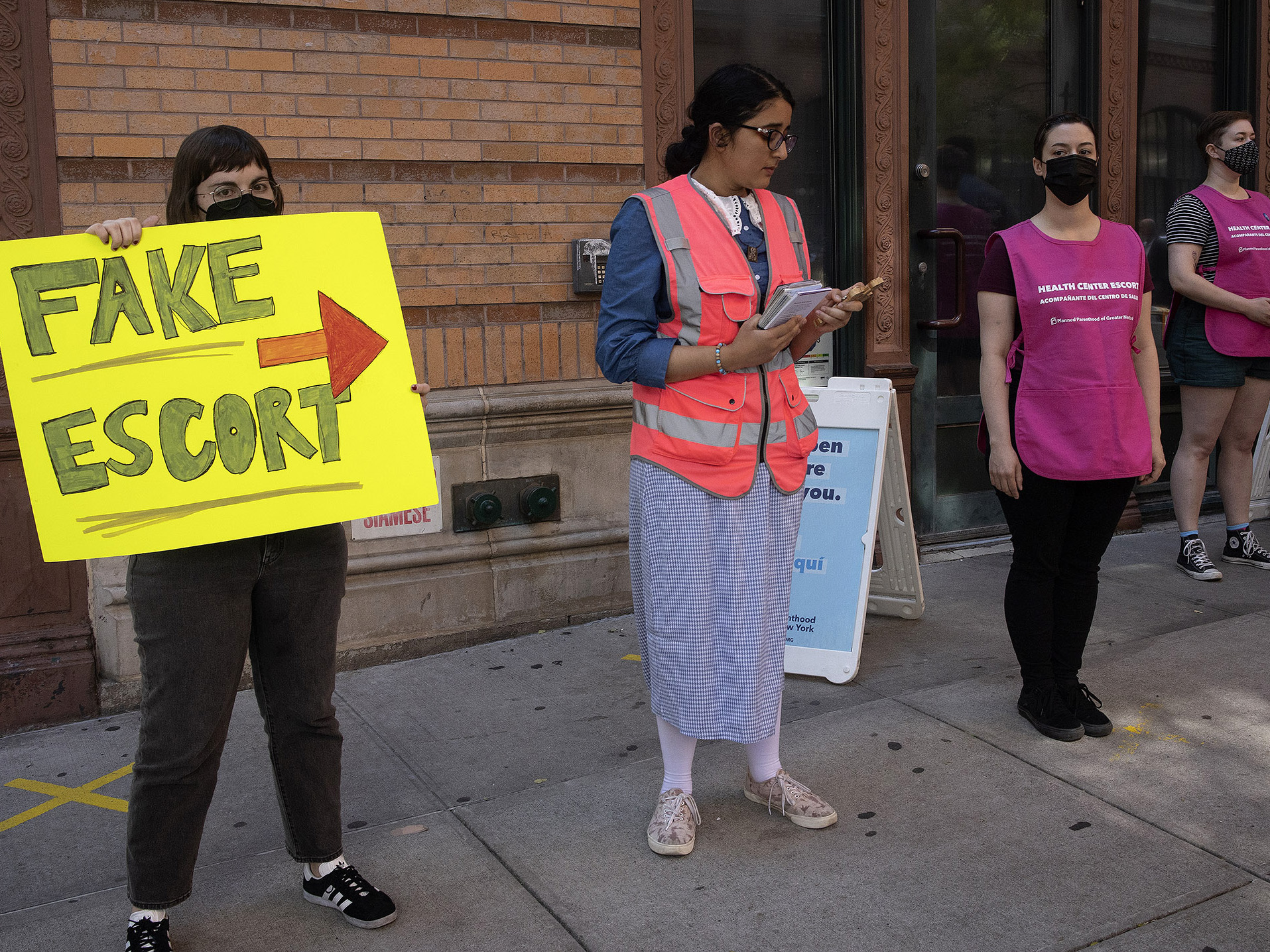 An abortion rights demonstrator holds a sign next to an anti-abortion protester outside a Planned Parenthood clinic in New York City on June 4.