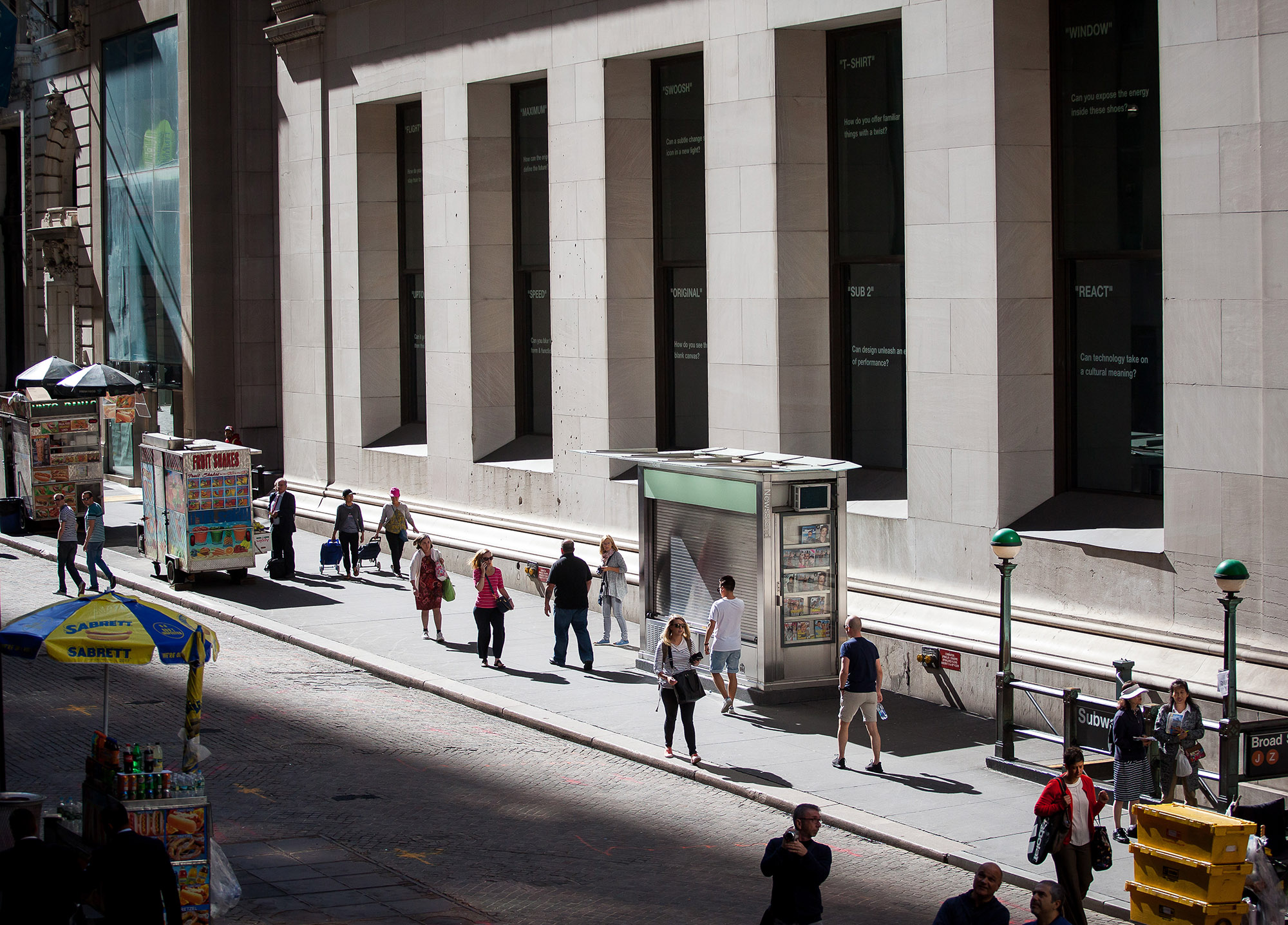 Pedestrians walk along Wall Street near the New York Stock Exchange (NYSE) in New York.