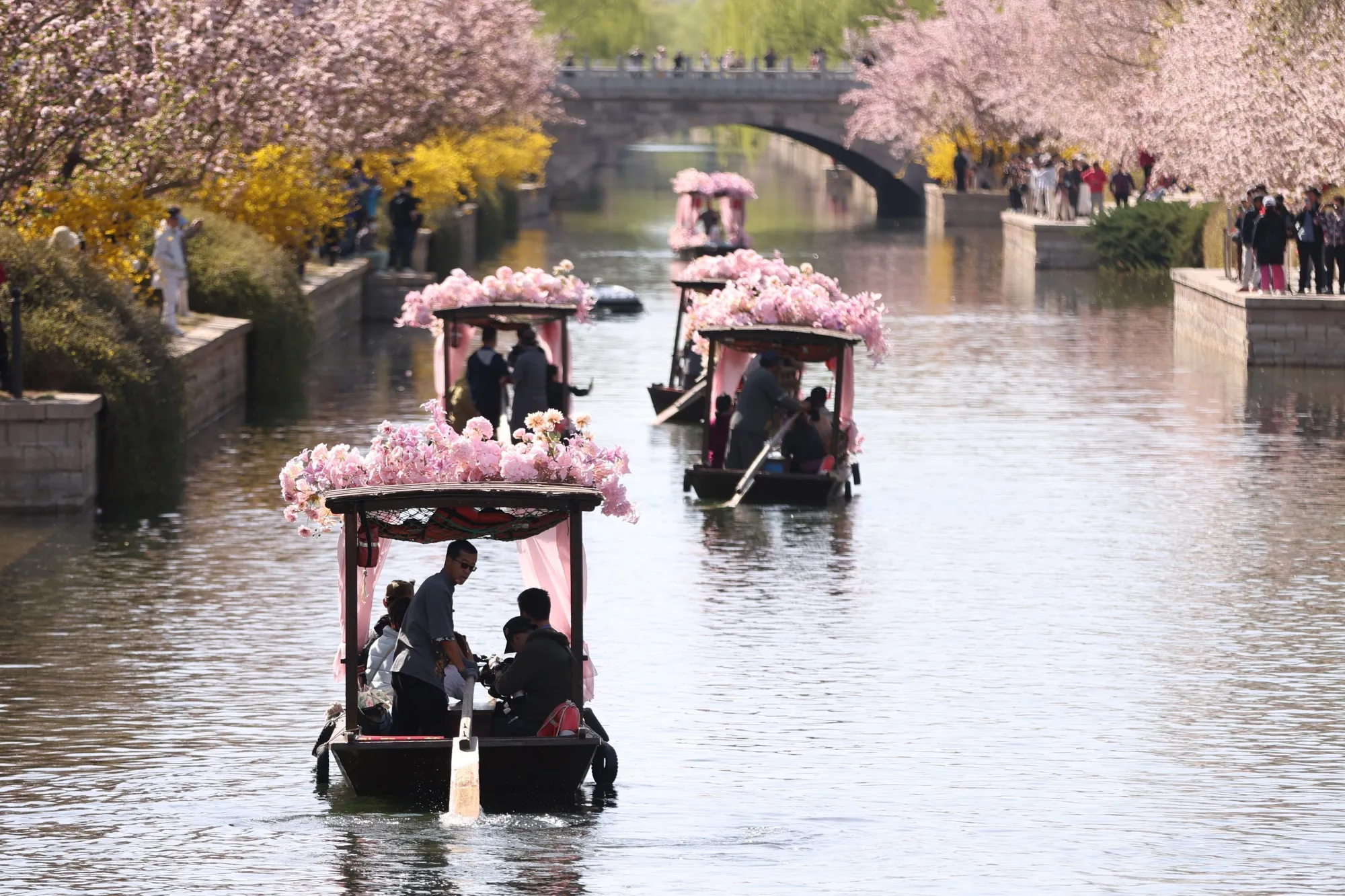Tourists take boat rides at Yuan Dynasty City Wall Relics Park in Beijing.