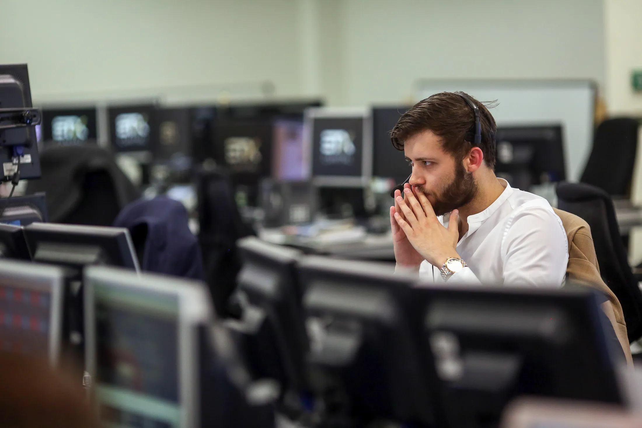 A trader monitors financial data on computers screens at ETX Capital, a broker of contracts-for-difference, in London, U.K. on Thursday, June 23, 2016. The pound headed for its biggest-ever drop, leading a decline in U.K. assets, as early results in Britain's European Union referendum pointed to a potential victory for the 'Leave' campaign.
