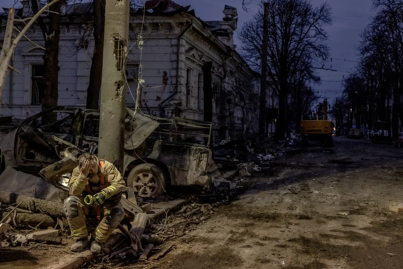 A Ukrainian rescuer takes a break at the site of a missile attack in Sumy, Ukraine, on April 13.