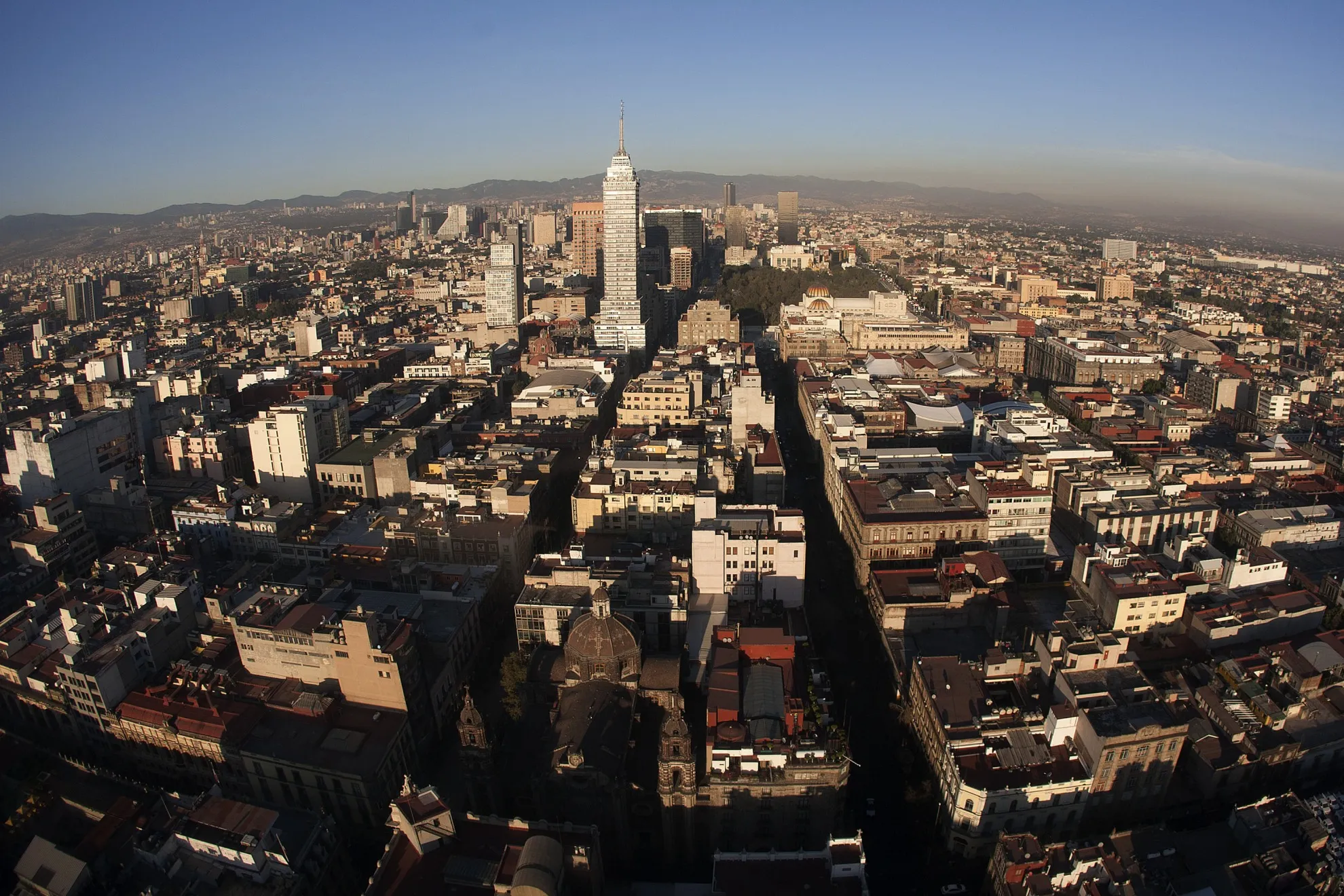 The Latin American Tower, center, stands in the city skyline in this aerial photograph taken from a helicopter in the Condor Group, a fleet of helicopters operated by the Federal District Secretariat of Public Security, in Mexico City.
