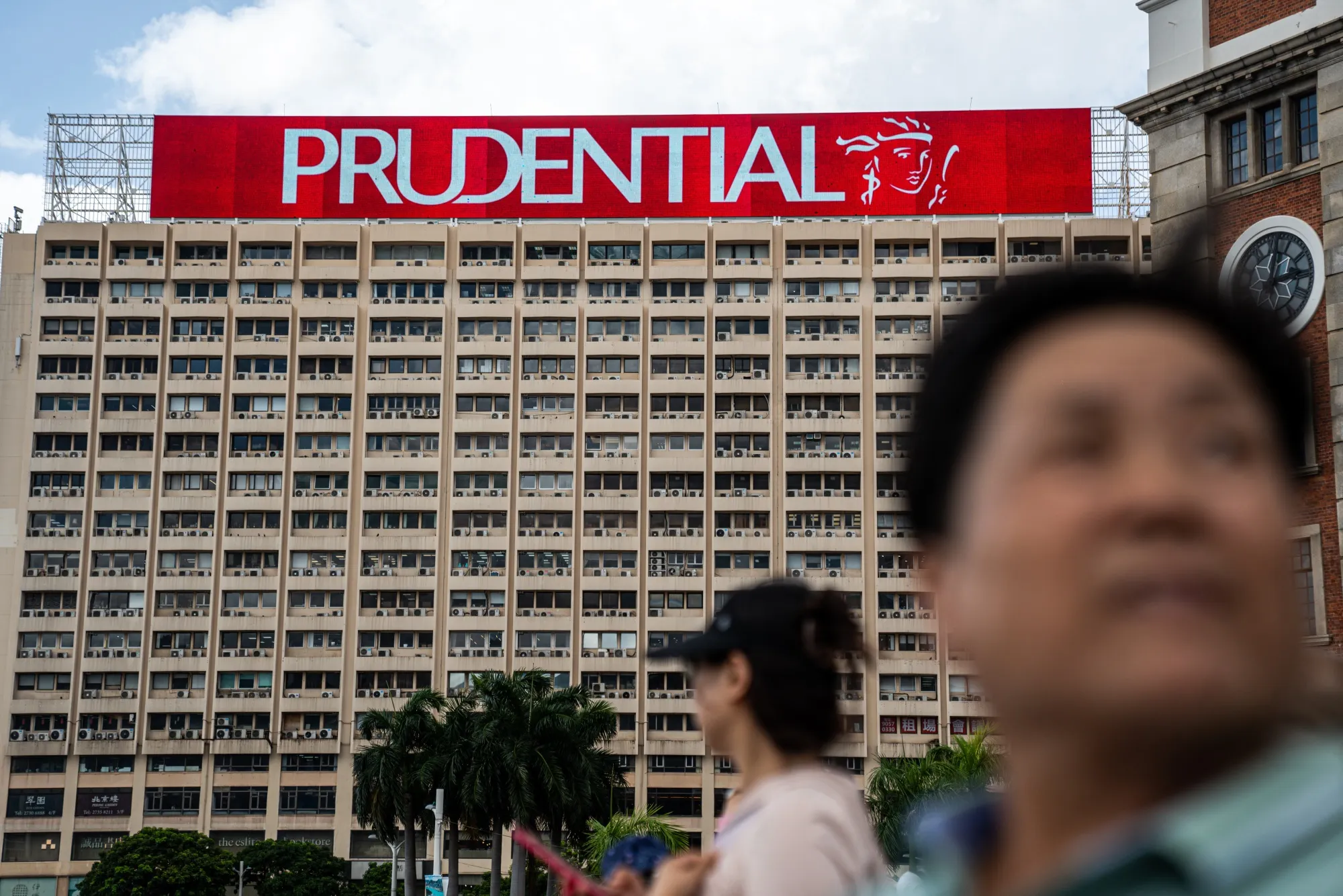 Signage for Prudential Plc atop a building in Hong Kong.