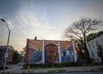 The sun sets behind a mural of the late Freddie Gray in Baltimore. Though he would eventually symbolize a far more visible tragedy, his life also represents that of many young children in Baltimore who have been poisoned by lead paint.