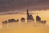 EDITORS NOTE: Multiple exposures were combined in camera to produce this image. An image of clouds at sunset overlays the skyscraper skyline of the financial district in Frankfurt, Germany, on Monday, July 1, 2019. Following the collapse of merger talks between Deutsche Bank and Commerzbank, German Finance Minister Olaf Scholz changed his message from supporting a national champion to backing a cross-border merger.