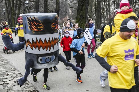 Protesters in costumes run in an anti-smog demonstration in Krakow and call for cleaner air.