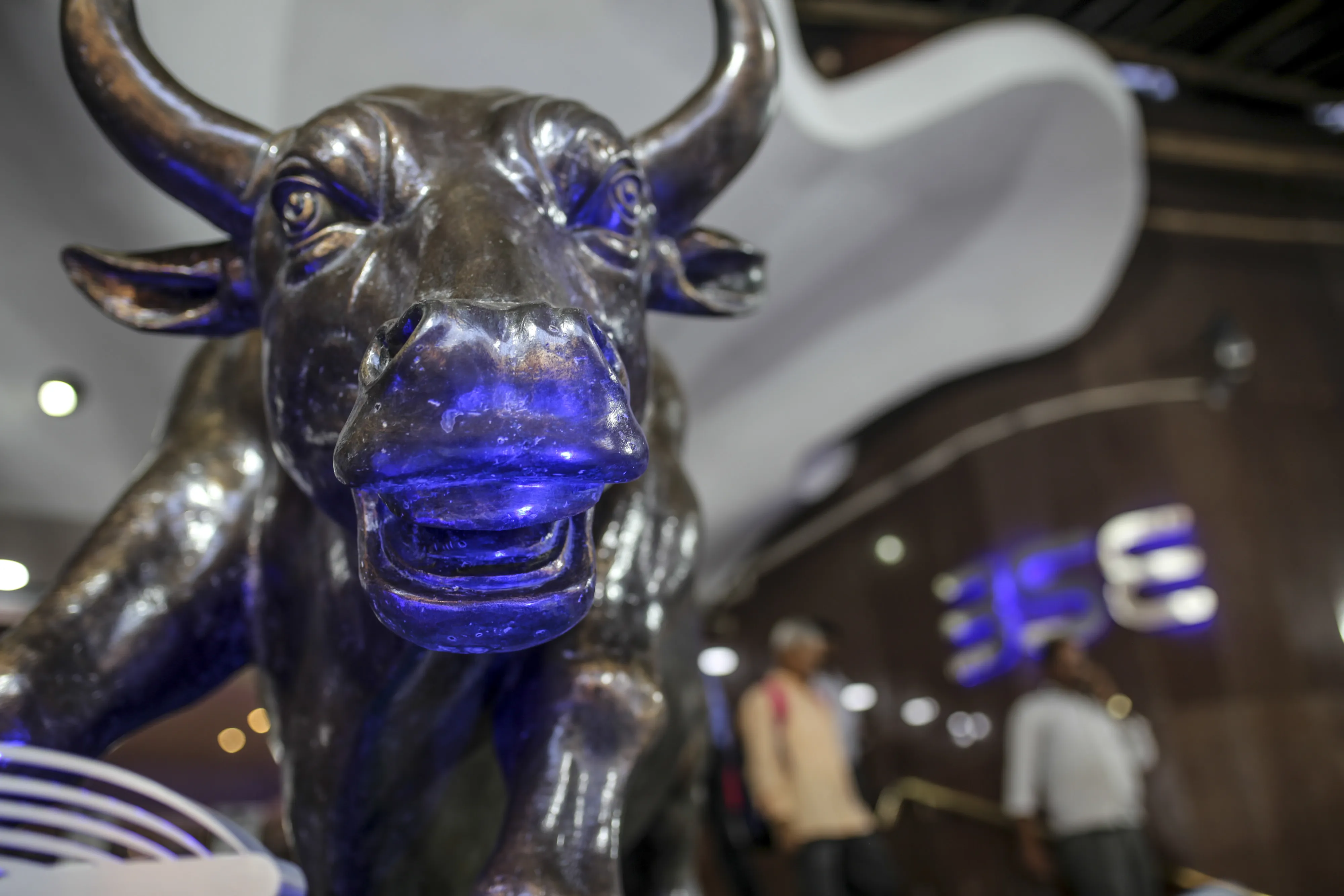 A bronze bull statue stands at the entrance of the BSE building in Mumbai.