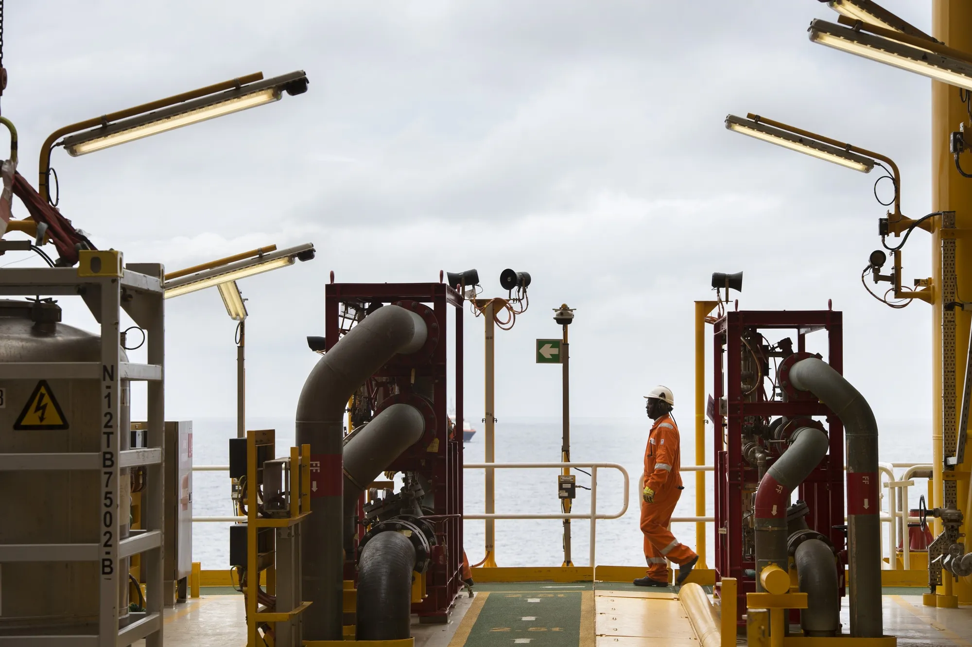 A worker walks on an oil tanker converted into a Floating Production Storage and Offloading vessel&nbsp;off the coast of Angola.