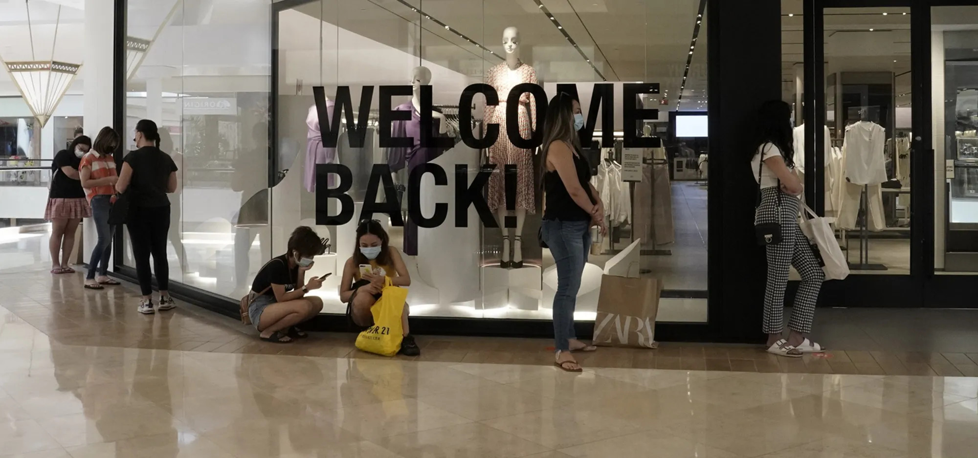 Shoppers wait in line to enter a store at the South Coast Plaza shopping mall in Costa Mesa, California,&nbsp;on&nbsp;June 15.