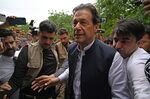 Imran Khan, center,&nbsp;arrives to appear before the an anti-terrorism court in Islamabad on Aug.&nbsp;25.