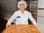 Miss Jackie holds a tray of Snickerdoodle Blondies at Greyston Bakery